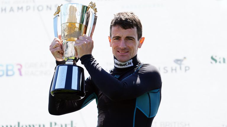 Brian Hughes with the Champion Jockey trophy at Sandown Park Racecourse