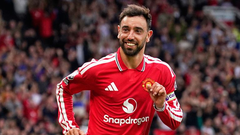 Bruno Fernandes wheels away after scoring his hat-trick (AP Photo/Dave Thompson)