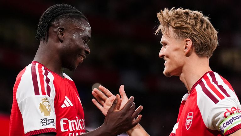 Arsenal's Bukayo Saka celebrates scoring his side's second goal against Coventry with Martin Odegaard 