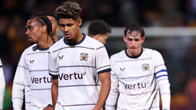 Burnley players look dejected after exiting the Carabao Cup