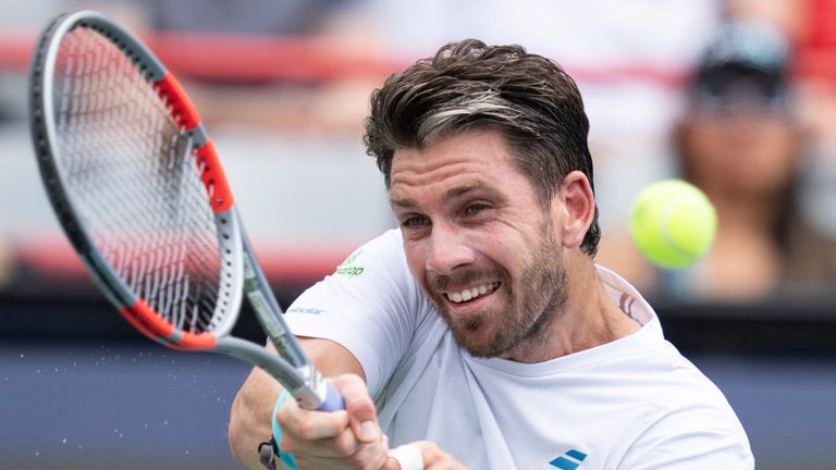 Cameron Norrie of Great Britain hits a return to Alex De Minaur of Australia during a third round tennis match at the National Bank Open in Montreal, Thursday, Aug. 6, 2026. (Christinne Muschi/The Canadian Press via AP)