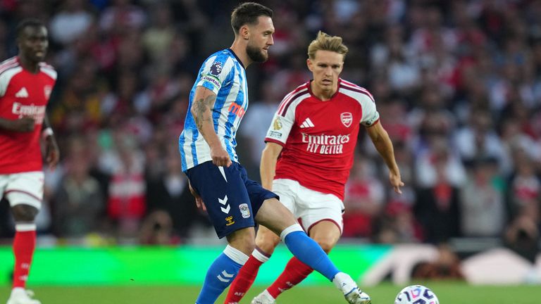 Coventry City's Matt Grimes passes the ball in front of Arsenal's Martin Odegaard (AP Photo/Kirsty Wigglesworth)