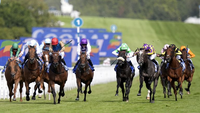 Evening Saigon (red cap) ridden by James Doyle on their way to winning the Coral Stewards' Cup during day five of the Goodwood Festival