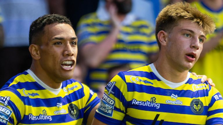 Ewan Irwin (R) celebrates scoring one of Warrington's five tries