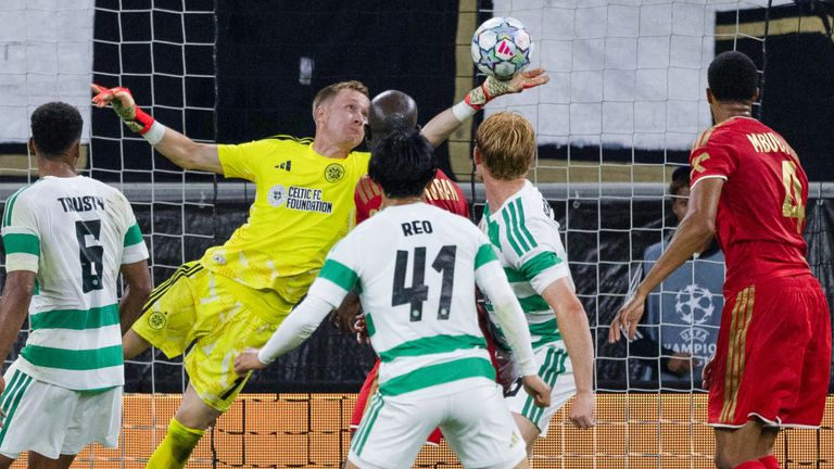 Celtic goalkeeper Viljami Sinisalo makes a save before LASK's Florian Flecker scores to make it 4-1 
