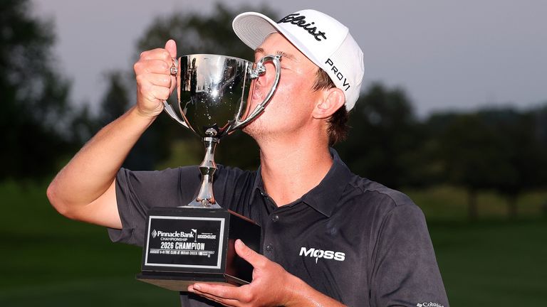 Frankie Harris celebrates with the trophy after winning the PGA Tour's Pinnacle Bank Championship