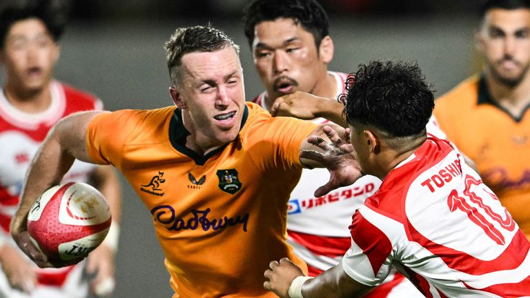 Harry Potter runs with the ball during Australia's win over Japan