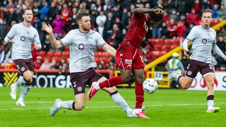 ABERDEEN, SCOTLAND - AUGUST 01: Hearts' Stuart Findlay (L) fouls Aberdeen's Toyosi Olusanya (R) leading to a red card and a penalty during a William Hill Premiership match between Aberdeen and Heart of Midlothian at Pittodrie Stadium, on August 01, 2026, in Aberdeen, Scotland. (Photo by Paul Devlin / SNS Group)