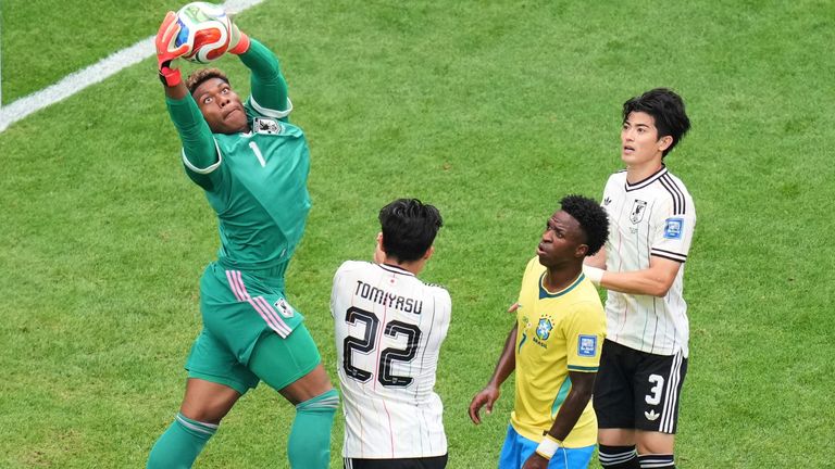 Japan goalkeeper Suzuki catches the ball during the World Cup game against Brazil