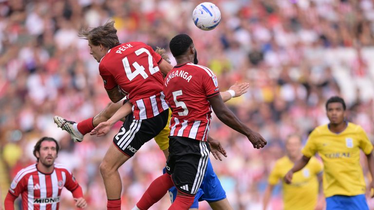 Sheffield United's Japhet Tanganga (right) heads the ball during the Sky Bet Championship match at Bramall Lane