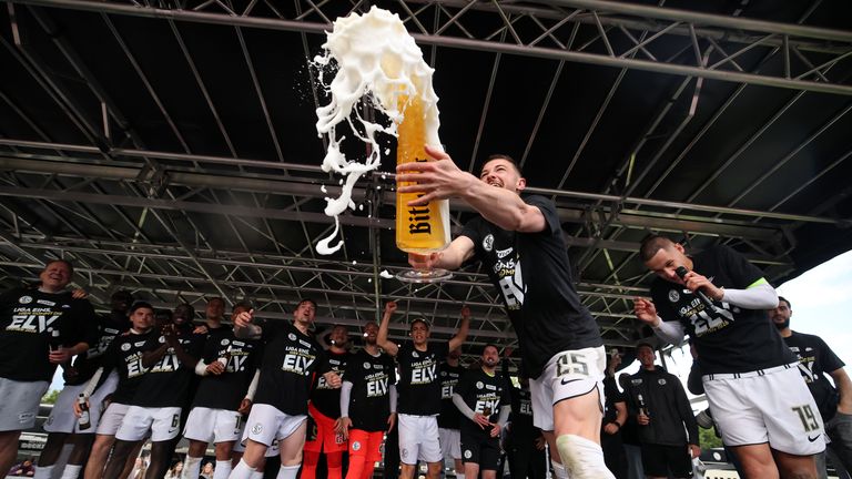 Lukas Petkov of Elversberg celebrating the team's promotion to the Bundesliga