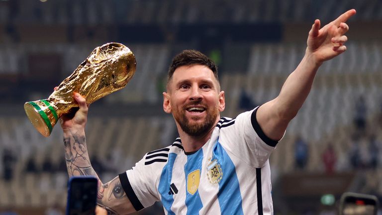 Lionel Messi celebrates with the World Cup trophy after Argentina's triumph in 2022
