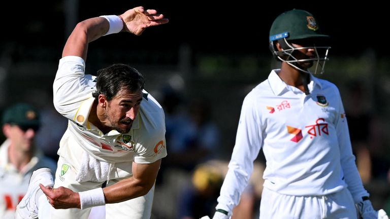 Australia's Mitchell Starc (L) sends down a delivery as Bangladesh batsman Hasan Mahmud (R) looks on on the second day of the first cricket Test match between Australia and Bangladesh at Marrara Stadium in Darwin on August 14, 2026. (Photo by William WEST / AFP) / --IMAGE RESTRICTED TO EDITORIAL USE - STRICTLY NO COMMERCIAL USE--