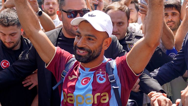 Mohamed Salah, wearing a Trabzonspor jersey, gestures to supporters upon arrival at the airport in Istanbul (Samet Yalcin/DIA Photo via AP)