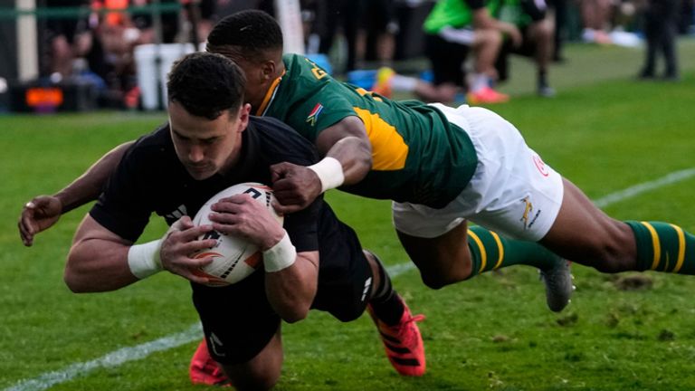 New Zealand's Will Jordan, front, scores a try as South Africa's Grant Williams tries to defend during a Test rugby match between South Africa and New Zealand, in Johannesburg, South Africa, Saturday, Aug. 22, 2026. (AP Photo/Themba Hadebe)