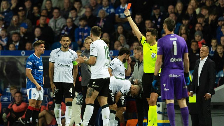 GLASGOW, SCOTLAND - AUGUST 20: Referee Marian Barbu shows a red card to Rangers Cammy Devlin during a UEFA Conference League Playoff Round First Leg match between Rangers and Jablonec, at Ibrox Stadium, on August 20, 2026, in Glasgow, Scotland. (Phot
