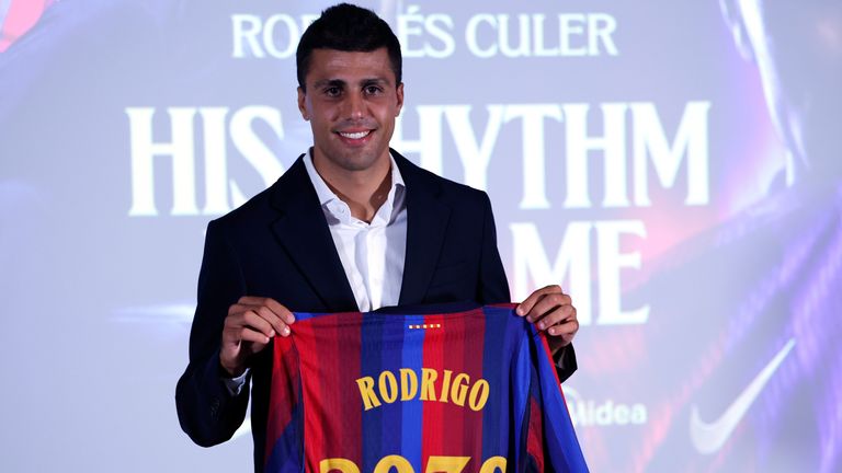 Rodri poses with his shirt at his Barcelona unveiling after leaving Man City