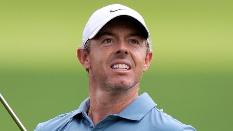 Rory McIlroy, of Northern Ireland, watches his shot from the rough on the first fairway during the first round of the Tour Championship