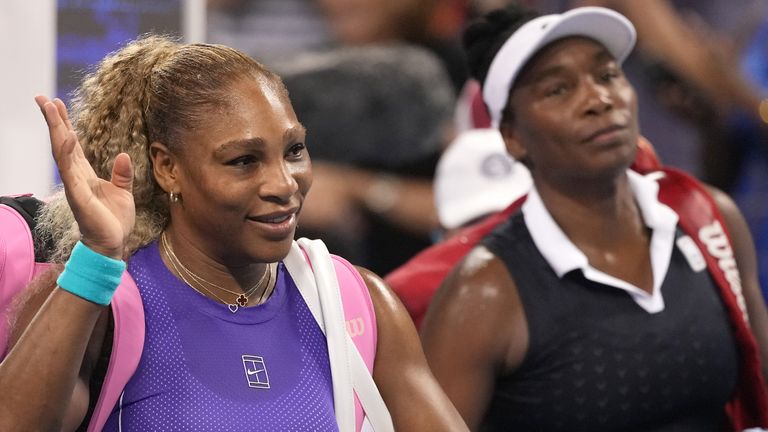 Serena Williams, left, and Venus Williams, right, both of the United States, wave to the crowd at the end of a women's doubles match