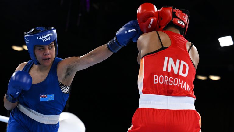 GLASGOW, SCOTLAND - JULY 31: Tarona Khanum Badi Pasoni Taafaki of Team Tuvalu punches Lovlina Borgohain of Team India during the Women's 75k
