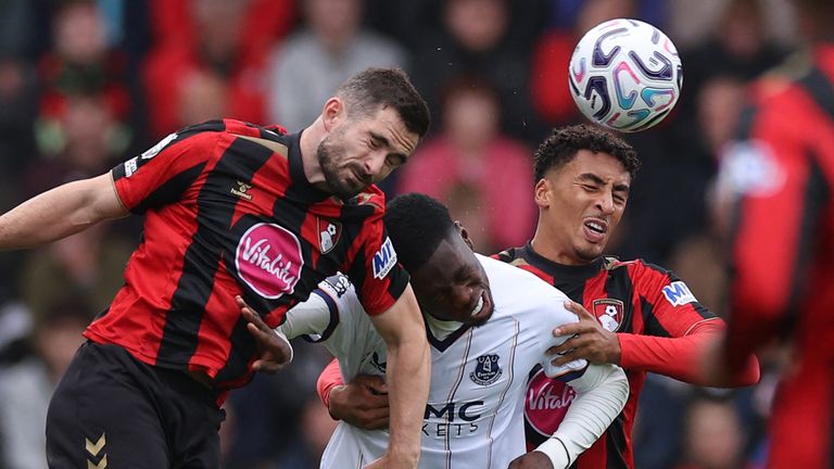 Thierno Barry competes for a header with Lewis Cook (L) and James Hill (R)