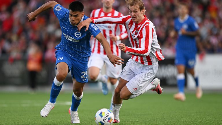 Brighton's Diego Gomez runs with the ball whilst under pressure from Tromso's Mathias Tonnessen
