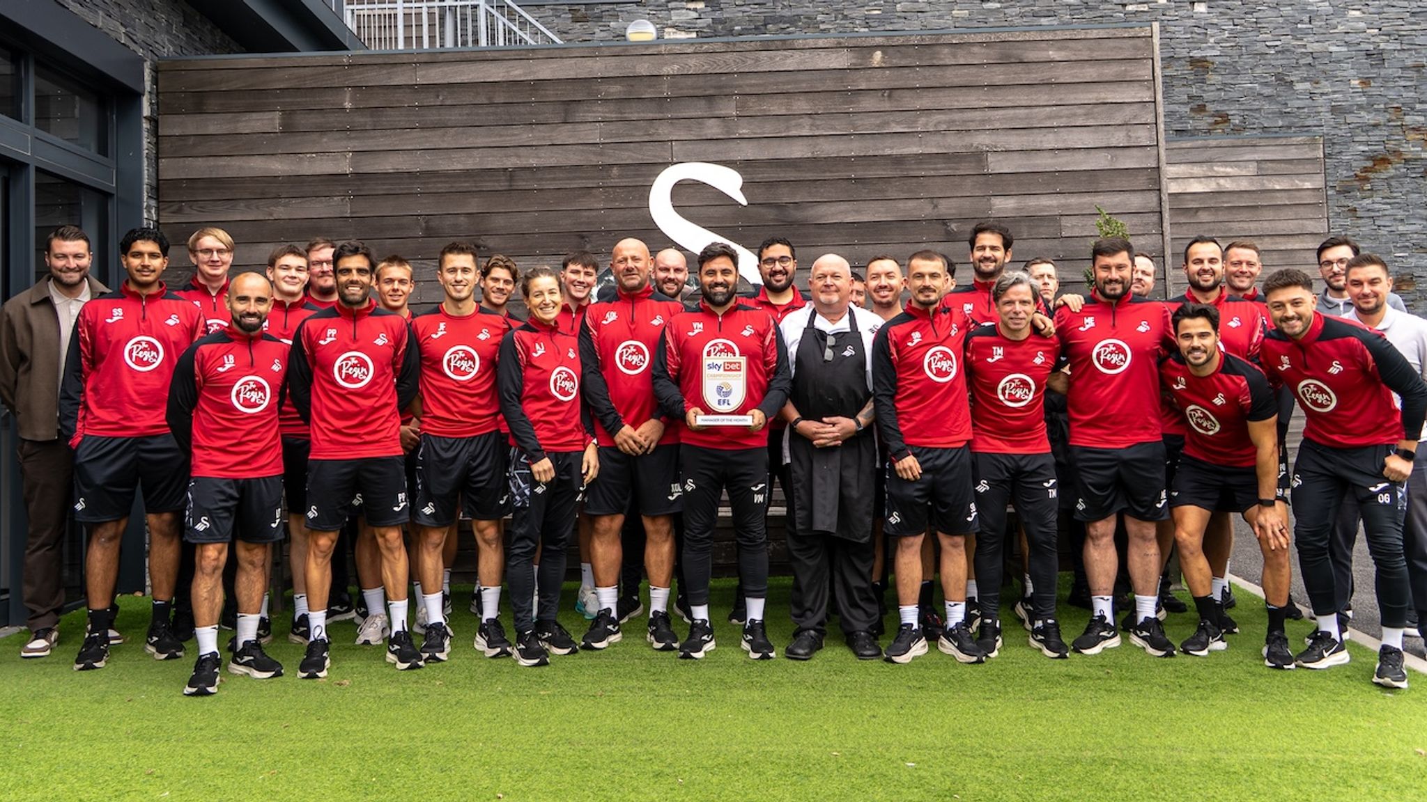 Vitor Matos poses with his Swansea City staff after winning the Sky Bet Championship Manager of the Month award for August