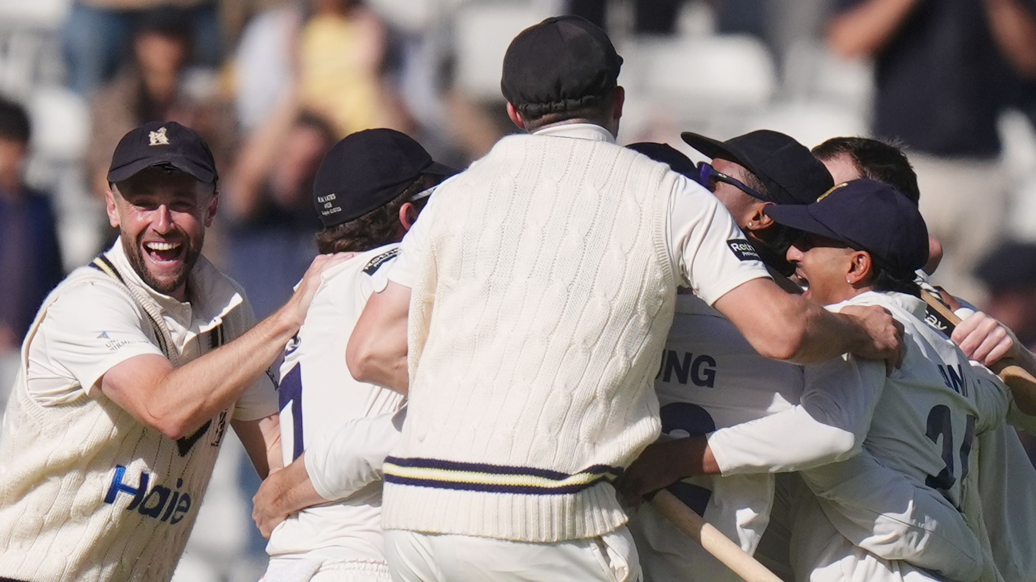 Warwickshire players celebrate after beating Leicestershire by an innings to win the County Championship Division One title