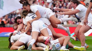 England's players mob Zoe Harrison after her try in added time sealed a 26-19 win over New Zealand