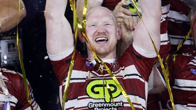 Liam Farrell celebrates with the Super League Grand Final trophy in 2024
