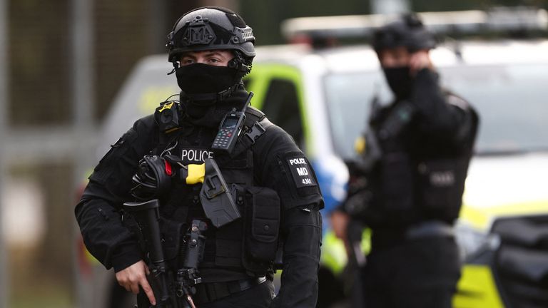 An armed police officer stands guards on a road outside the perimeter of the RAF Fairford airbase.
Pic: Reuters