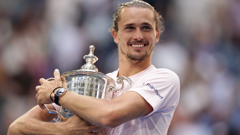 Alexander Zverev, of Germany, poses with the trophy after he won the men's singles final of the U.S. Open tennis championships against Ben Shelton, of the United States, Sunday, Sept. 13, 2026, in New York. (AP Photo/Adam Hunger)