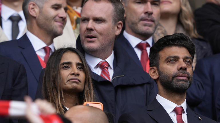 Amit Bhatia in front of Liverpool sporting director Richard Hughes and next to his wife Vanisha Mittal Bhatia at Anfield