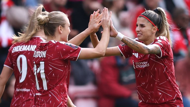 Liverpool 's Beata Olsson celebrates scoring her team’s first goal with team-mate Natalia Ramos Alvarez