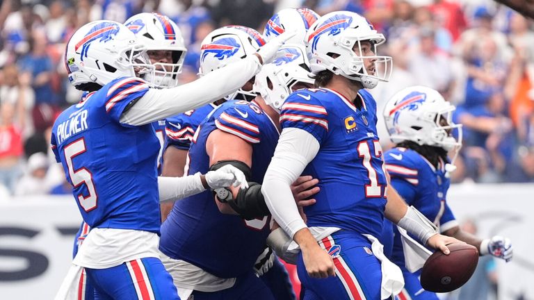Buffalo Bills quarterback Josh Allen (17) celebrates with teammates after scoring a 21-yard touchdown run