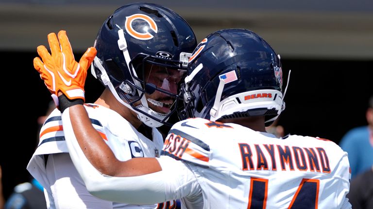 Chicago Bears quarterback Caleb Williams (18) celebrates with wide receiver Kalif Raymond (14) after scoring a touchdown during the first half of an NFL football game, Sunday, Sept. 13, 2026, in Charlotte, N.C. (AP Photo/Erik Verduzco)