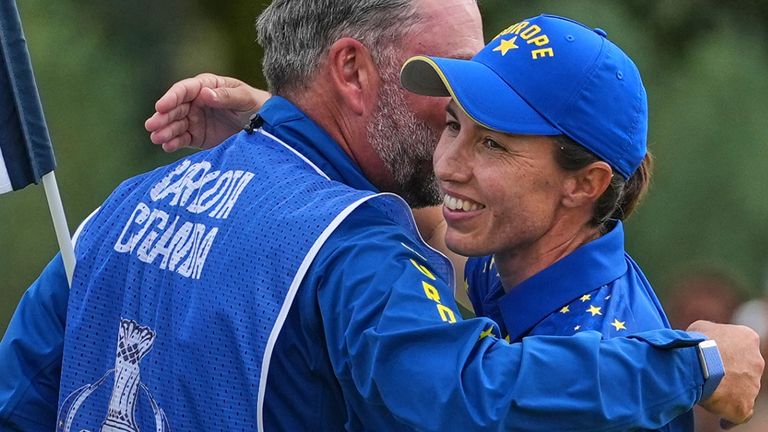 Carlota Ciganda embraces her caddie after beating Jennifer Kupcho