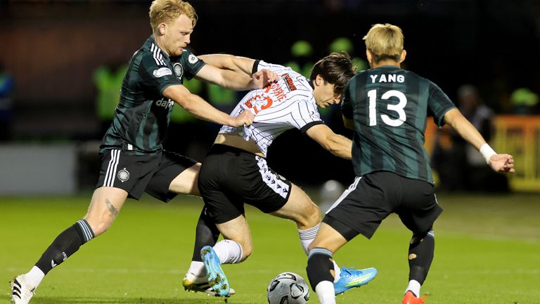 St Mirren's Chris Mochrie (centre) battles for the ball with Celtic's Liam Scales (left) and Yang