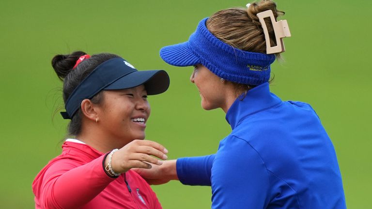 Charley Hull of Europe, right, embraces Megan Khang of the United States after winning their singles match during the Solheim Cup