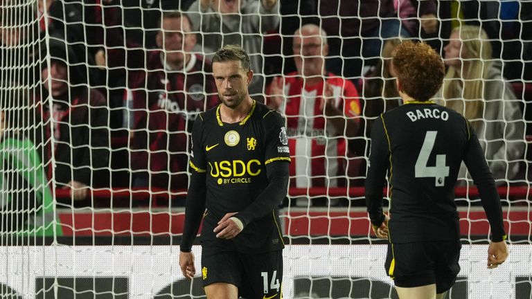 Chelsea players stand dejected after conceiding third goal 