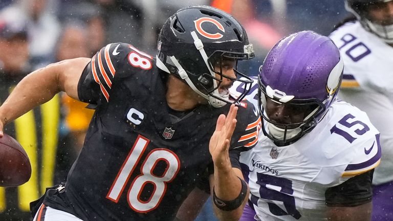 Chicago Bears quarterback Caleb Williams runs from Vikings pass rusher Dallas Turner 