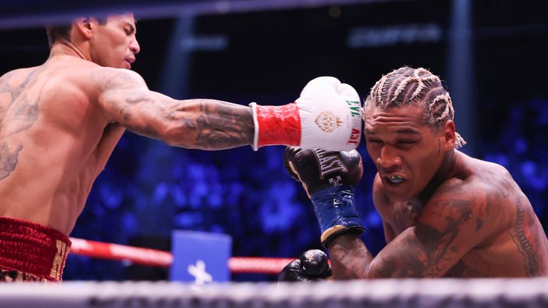 Ryan Garcia, left, punches Conor Benn in their welterweight championship fight Saturday, Sept. 12, 2026, in Las Vegas. (AP Photo/Ian Maule)