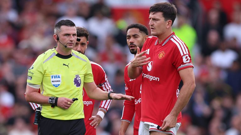 Referee Michael Oliver and Man Utd's Harry Maguire