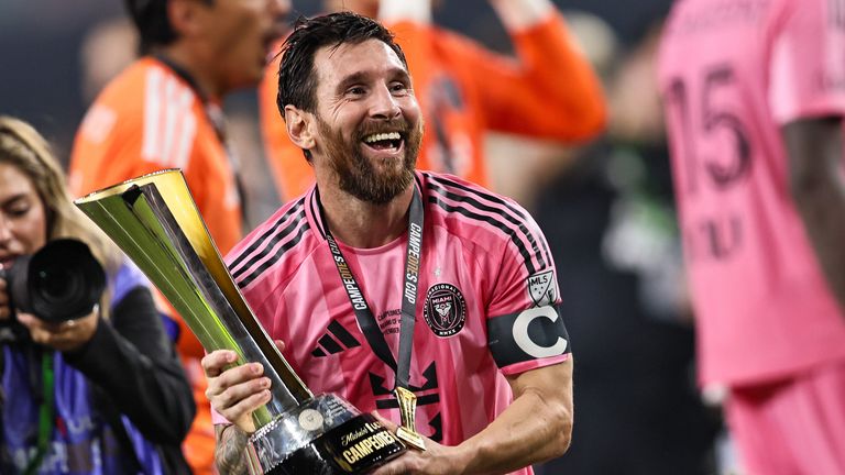 Inter Miami orward Lionel Messi celebrates with the Michelob Champions Trophy