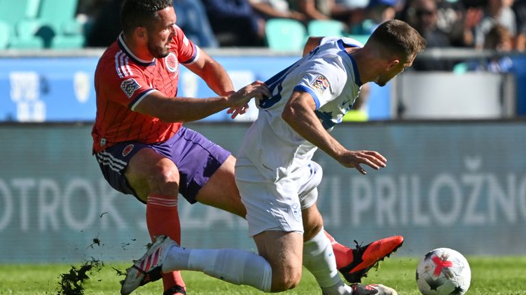 Scotland's John McGinn, left, challenges Slovenia's Timi Max Elsnik