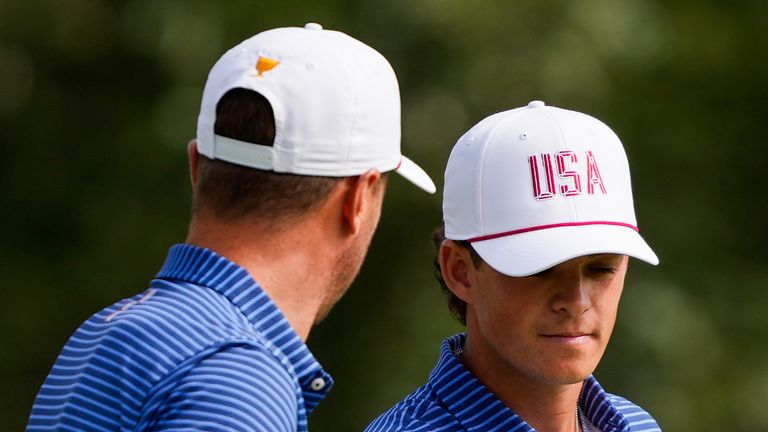 Justin Thomas celebrates with Jackson Koivun, right, on the seventh green during the first round four-ball match at the Presidents Cup