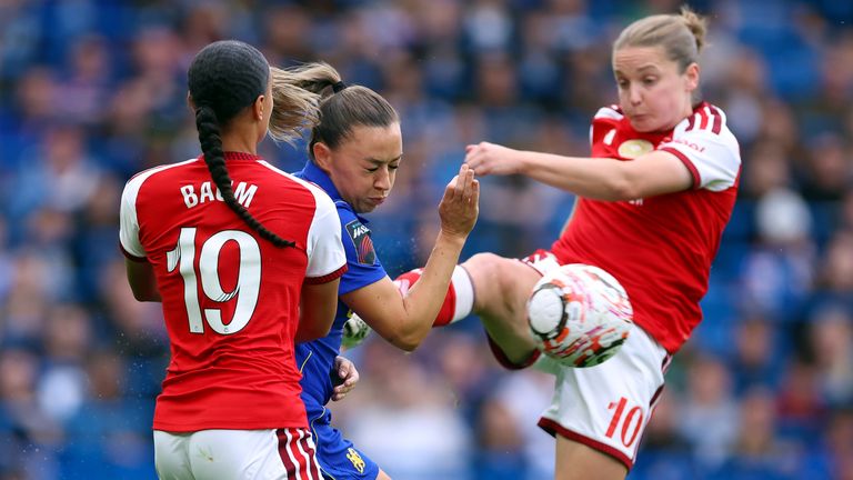 Katie McCabe competes for possession with Lisa Baum and Kim Little