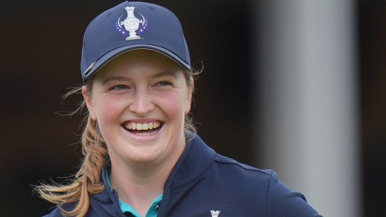 Lottie Woad of Europe reacts and laughs after she plays a shot from the 16th tee during a practice round 