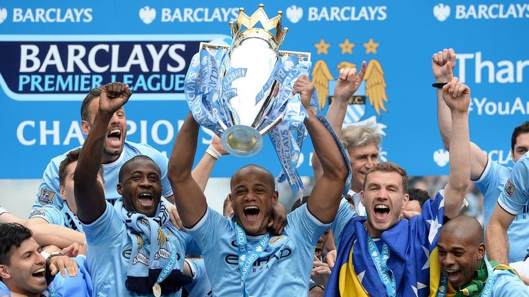Vincent Kompany lifts the Premier League trophy after winning the title with Man City in 2014
