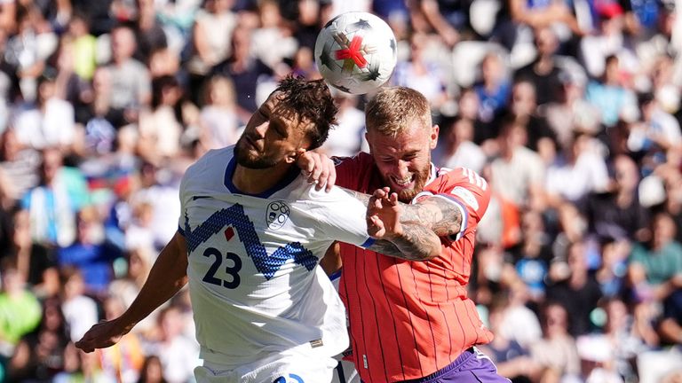Scotland's Oliver McBurnie (centre right) and Slovenia's David Brekalo battle for the ball